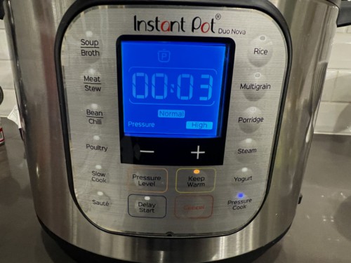 An Instant Pot with the timer set to 3 minutes.