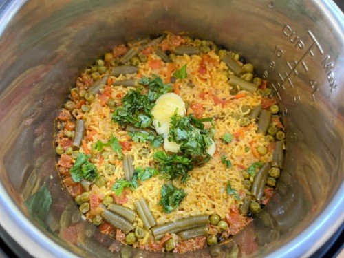 Garnishing Instant Pot masala rice with cilantro.