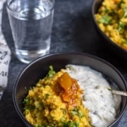 A bowl of Masala khichdi, topped with pickle.