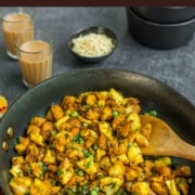 A non-stick skillet with bread upma and a wooden spoon with the words Bread Upma with Veggies at the top.