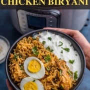 A black bowl with chicken biryani in the front and an Instant Pot in the back and the words Instant Pot Chicken Biryani at the top.