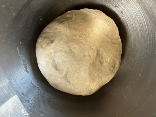 A silver bowl with lacha paratha dough.