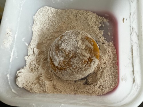 A round of paratha dough dipped in flour.