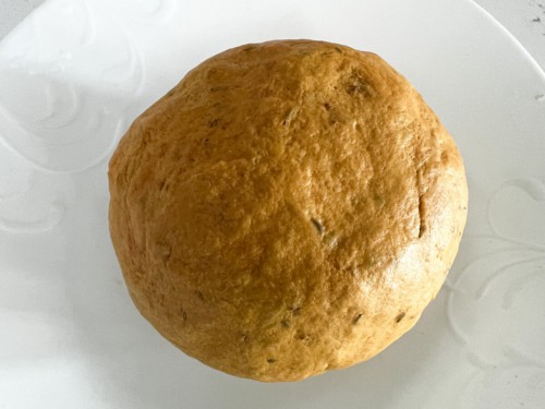 A ball of masala paratha dough after being kneaded into a ball.