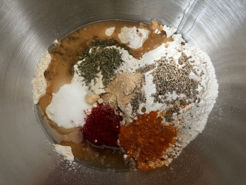 A silver bowl with masala paratha ingredients before mixing.