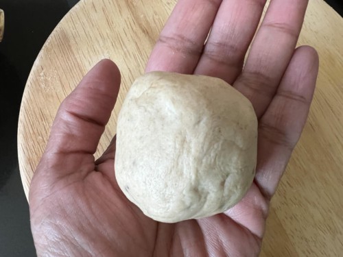 Shaping paratha dough into a bowl