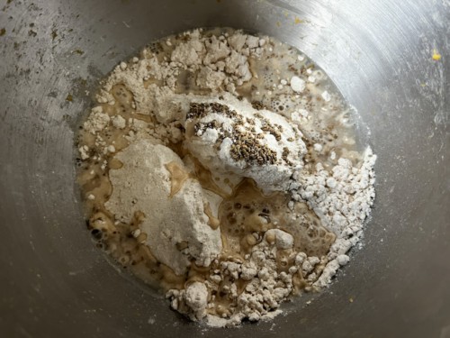 Combining wheat flour with other ingredients to make paratha.