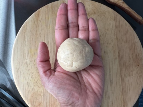 Shaping paratha dough into a bowl.