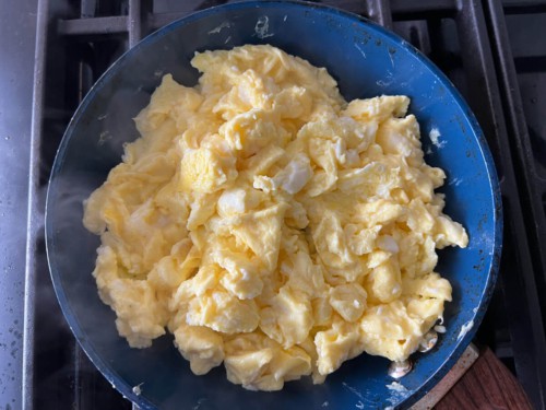 A non-stick skillet with fluffy scrambled eggs.