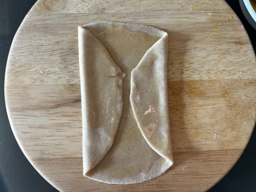 Folding dough in to make a rectangular shape.