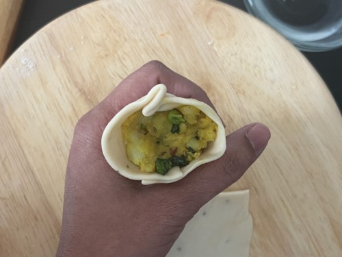 A dough cone filled with samosa stuffing.