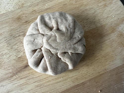 Pinching together paratha dough to seal.