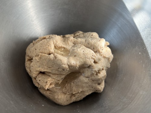 The dough is combined and sitting in the silver mixing bowl.