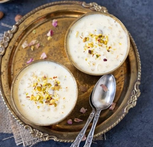 Two bowls of Sabudana kheer served in a metal plate