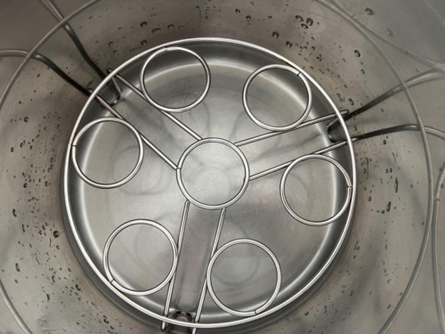 Trivet placed in a steel pot with water in it
