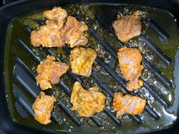 Chicken pieces seared in a pan